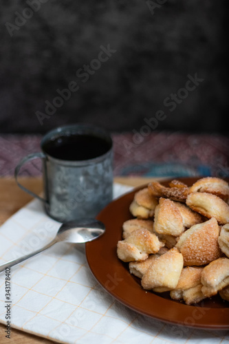 Crispy cottage cheese cookies lies on a brown plate