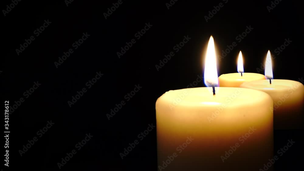 Three light candle burning brightly in the black background. Three light candle burning brightly in the black background.