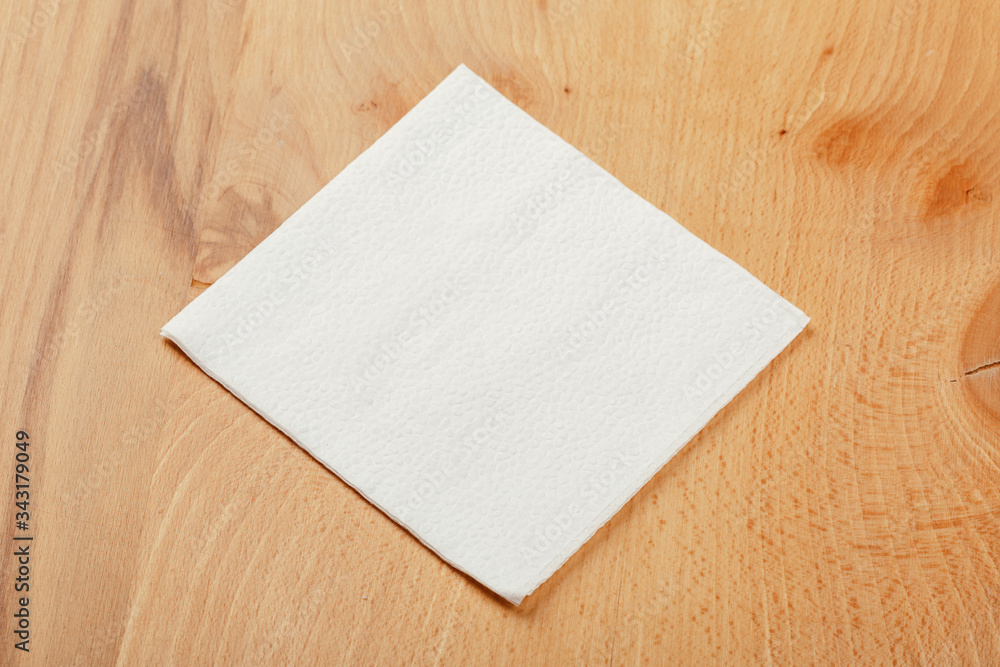 white paper napkin with a textured pattern on an old table white paper napkin with a textured pattern on an old table