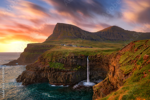 Gasadalur Waterfall into the Ocean in Faroe Islands photo