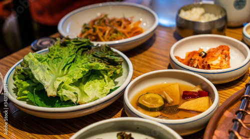 Korean barbecue sidedish with green lettuce, pickle and Kimchi