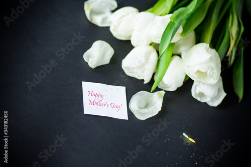 beautiful bouquet of white tulips on black background