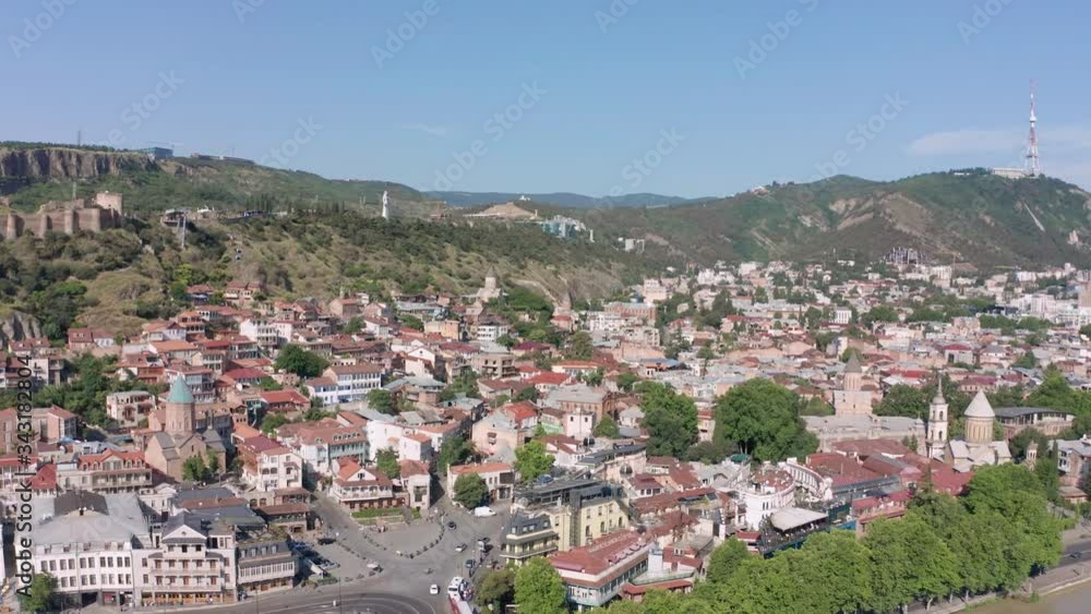 flight over of the old town on Sololaki hill, crowned with Narikala fortress, the Kura river and old buildings and city infrastructure in Tbilisi, Georgia. flight over of the old town on Sololaki hill, crowned with Narikala fortress, the Kura river and old buildings and city infrastructure in Tbilisi, Georgia.