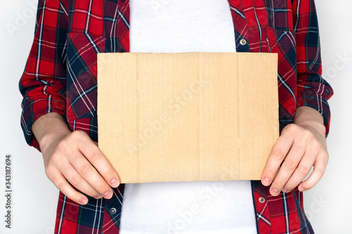 Woman in shirt hold empty cardboard. Template for text.