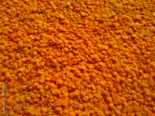 Red raw organic lentils texture. Food ingredient background. Natural