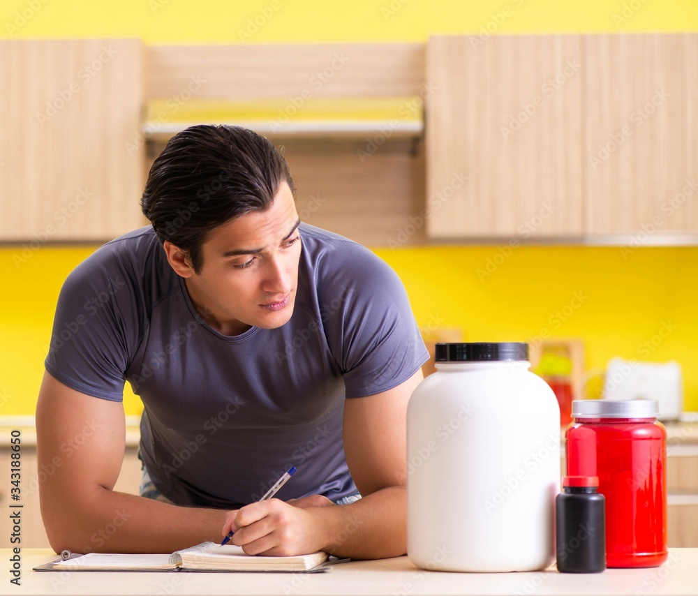 Young man blogging about food supplements Young man blogging about food supplements