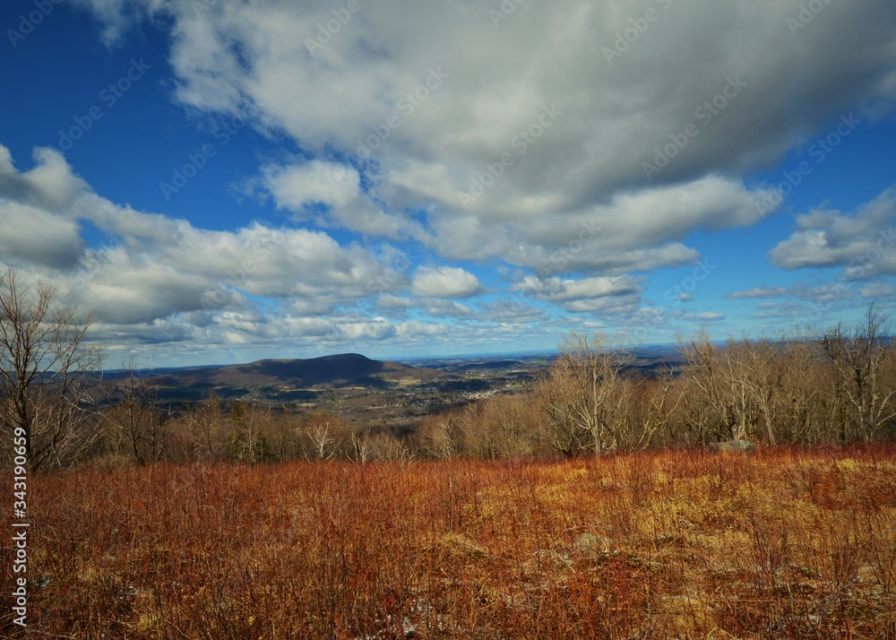 Blue Sky with Puffy White Clouds - Harmon Hill Mountain Top Lookout.  Dry earth foreground, early spring 2020