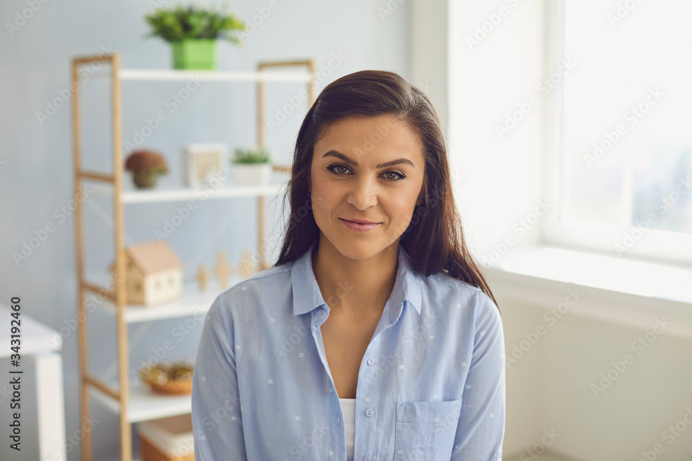 Businesswoman hispanic brunette in casual clothes serious looking at the camera at home in the office.