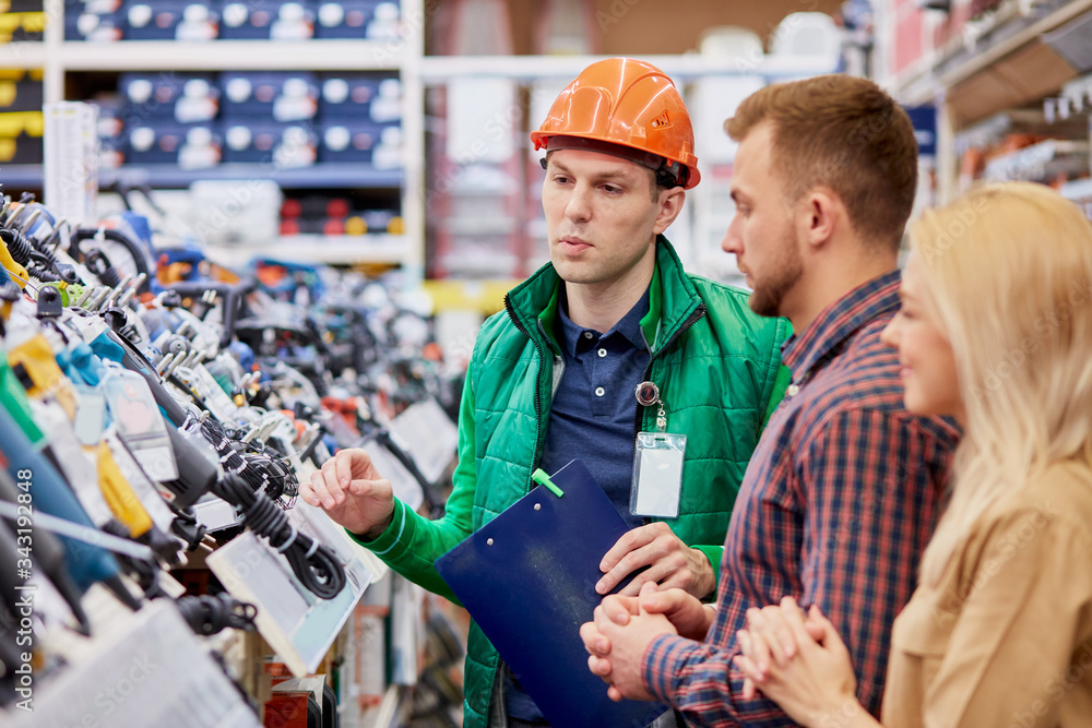 confident caucasian consultant in uniform glad to help to customers, talk about advantages of product confident caucasian consultant in uniform glad to help to customers, talk about advantages of product