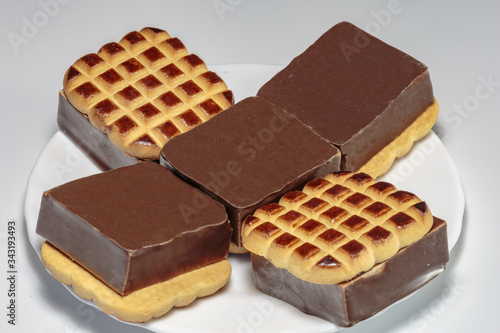 Sandwich cookies with vanilla souffle and chocolate. Sweet food from the shop.