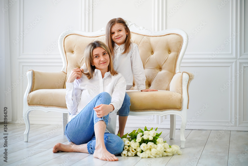 Portrait of little girl loving mother holding her and white tulips Portrait of little girl loving mother holding her and white tulips