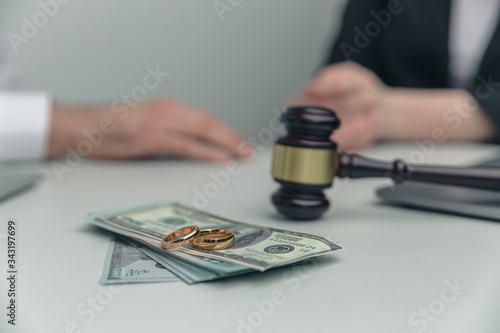 Legal alimony concept. Closeup view of wooden gavel and money
