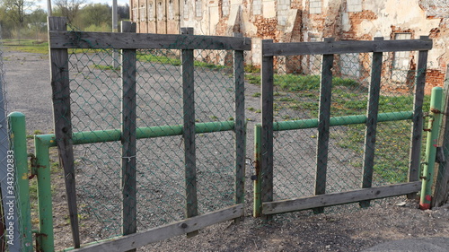 wooden gate closed with metal locker