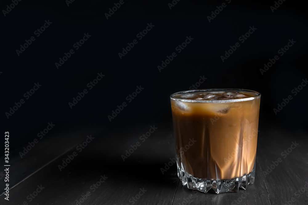 Splash of ice coffee drink on a brown background. Cold beverage wave. Close-up design liquor milk, coffee and ice. Splash of ice coffee drink on a brown background. Cold beverage wave. Close-up design liquor milk, coffee and ice.