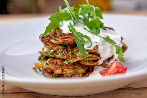 zucchini pancakes with sour cream and herbs