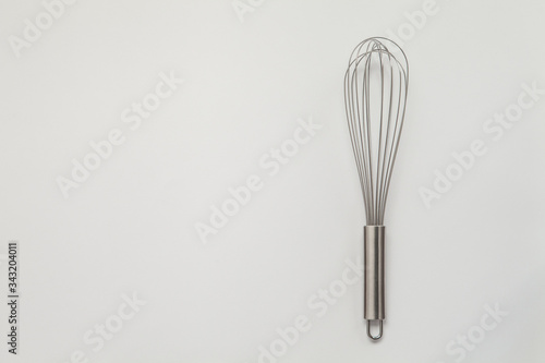 Metal whisk for whipping on a white background.