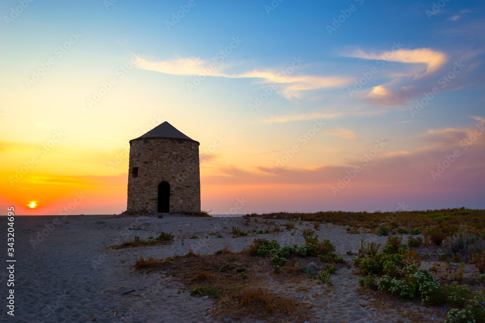 Old windmill at Agios Ioannis beach, Lefkada, Greece Old windmill at Agios Ioannis beach, Lefkada, Greece