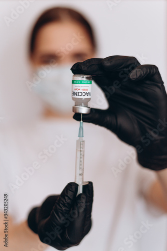 Doctor holds COVID 19 Coronavirus vaccine in his hand, Vaccine and syringe injection It use for prevention, immunization and treatment from COVID-19