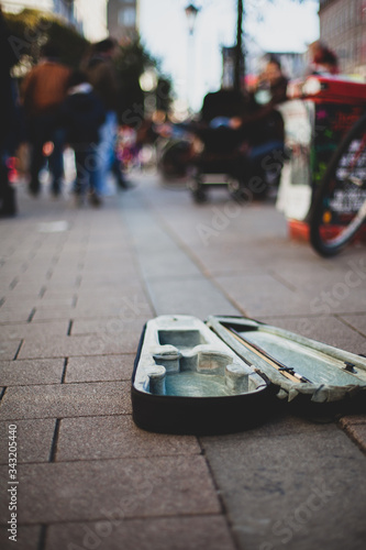 The open violin case of a street musician in the pedestrian zone of a city centre photo