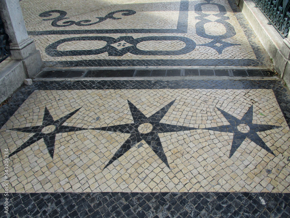 Traditional sidewalk of cobblestone pavement with stars in the city center of Lisbon. Portugal. 