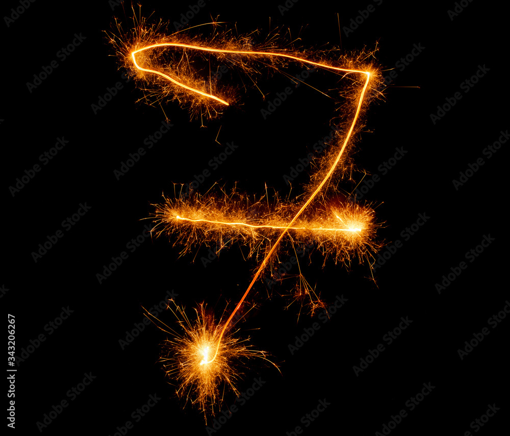 number seven written with a sparkler on a black background