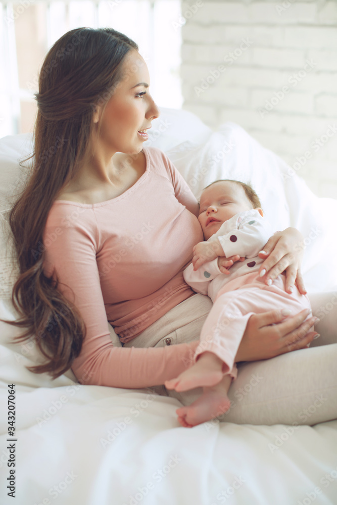 Beautiful woman with a baby is resting in a cozy house. Beautiful woman with a baby is resting in a cozy house.
