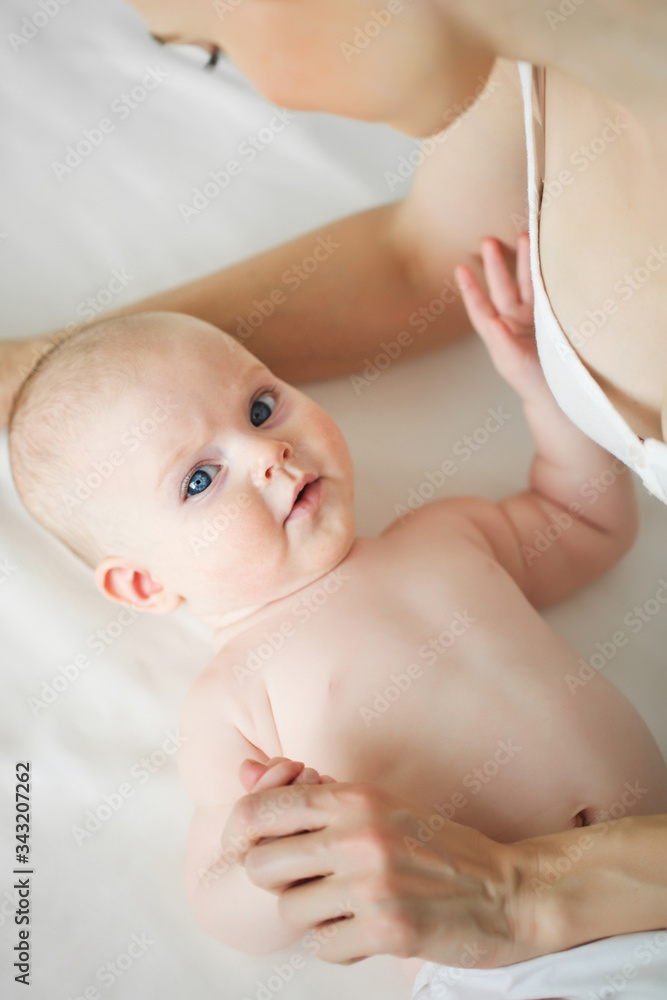 Woman with a baby on a white background. Mom holds the baby. Woman with a baby on a white background. Mom holds the baby.