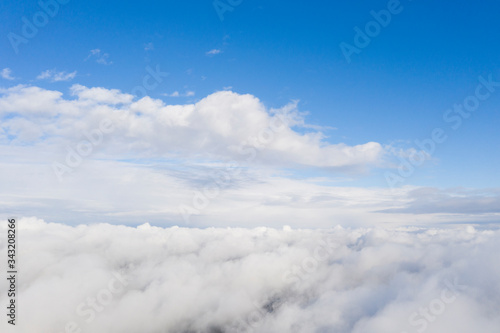 Fototapeta Naklejka Na Ścianę i Meble -  Aerial view white clouds in blue sky. View from drone. Aerial top view cloudscape. Texture of clouds. View from above. Sunrise or sunset over clouds. Panorama clouds