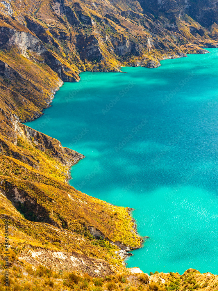 Vertical aerial landscape close up of the turquoise waters in the Quilotoa Crater Lake, south of Quito, Ecuador.