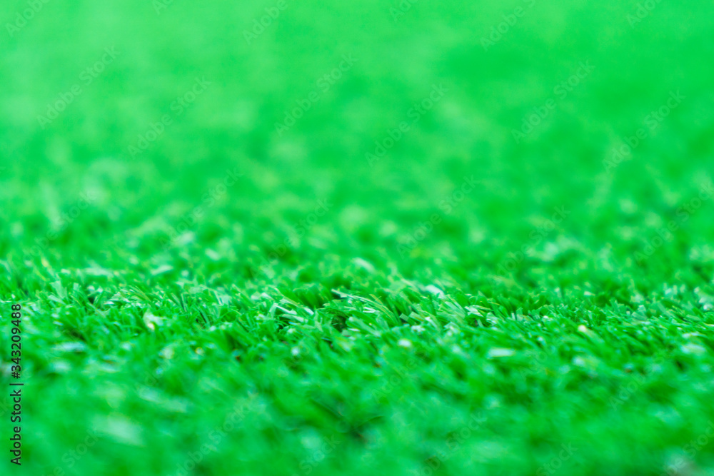 Fototapeta premium Artificial grass lawn texture. Artificial Turf Background. Greening with an artificial grass. Artificial turf laying background texture. Synthenic grass layer