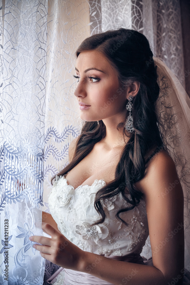 Fototapeta premium portrait of a bride near the window