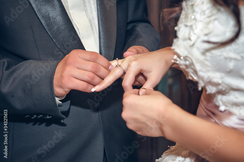 putting on wedding rings in the church © Andriy Petrenko