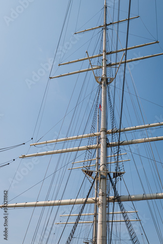 The empty masts of a three-masted sailing boat