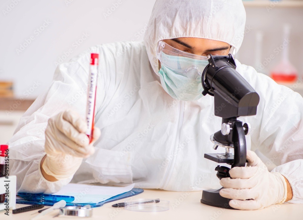 Young handsome lab assistant testing blood samples in hospital Young handsome lab assistant testing blood samples in hospital