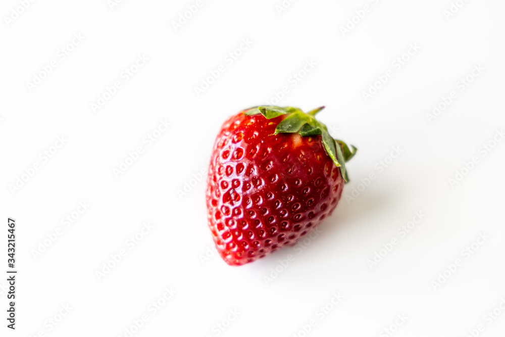 red juicy fresh ripe strawberry on a white herbed background red juicy fresh ripe strawberry on a white herbed background