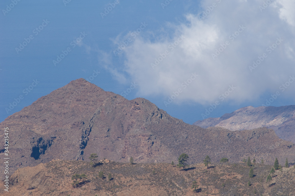 Mountain and cloud in the southwest of Gran Canaria. Aldea de San Nicolas de Tolentino. Gran Canaria. Canary Islands. Spain. Mountain and cloud in the southwest of Gran Canaria. Aldea de San Nicolas de Tolentino. Gran Canaria. Canary Islands. Spain.