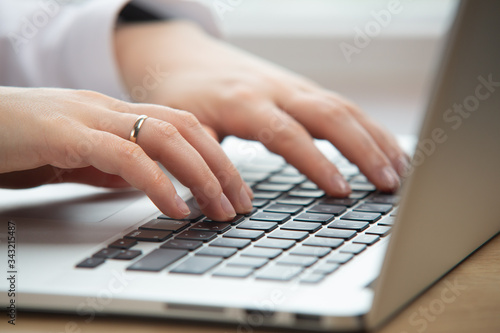 Woman hand working on a notebook using touchpad.