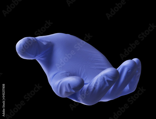 Hand surgery doctor glove isolated on black background.