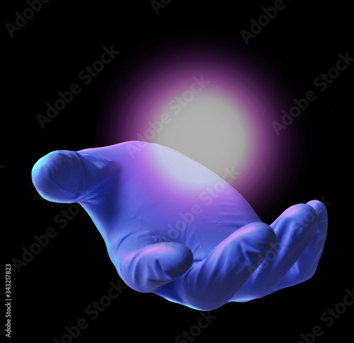 Floating glow ball on surgery doctor glove hand. Biotechnology concept