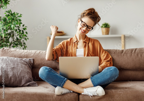 Delighted young woman celebrating victory in online lottery