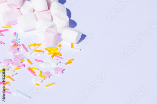 Sugar colorful sprinkles, stars and marshmallows, baking decorations in multicolor, bright picture, home made bakery White background with copy text space
