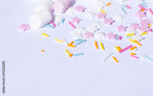 Sugar colorful sprinkles, stars and marshmallows, baking decorations in multicolor, bright picture, home made bakery White background with copy text space