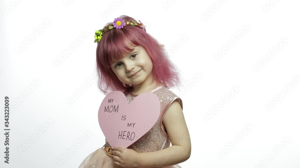 Child girl princess holds pink paper heart with text about mother. Mother's day Child girl princess holds pink paper heart with text about mother. Mother's day