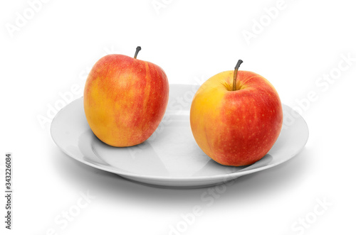 Two apples on white plate and white background