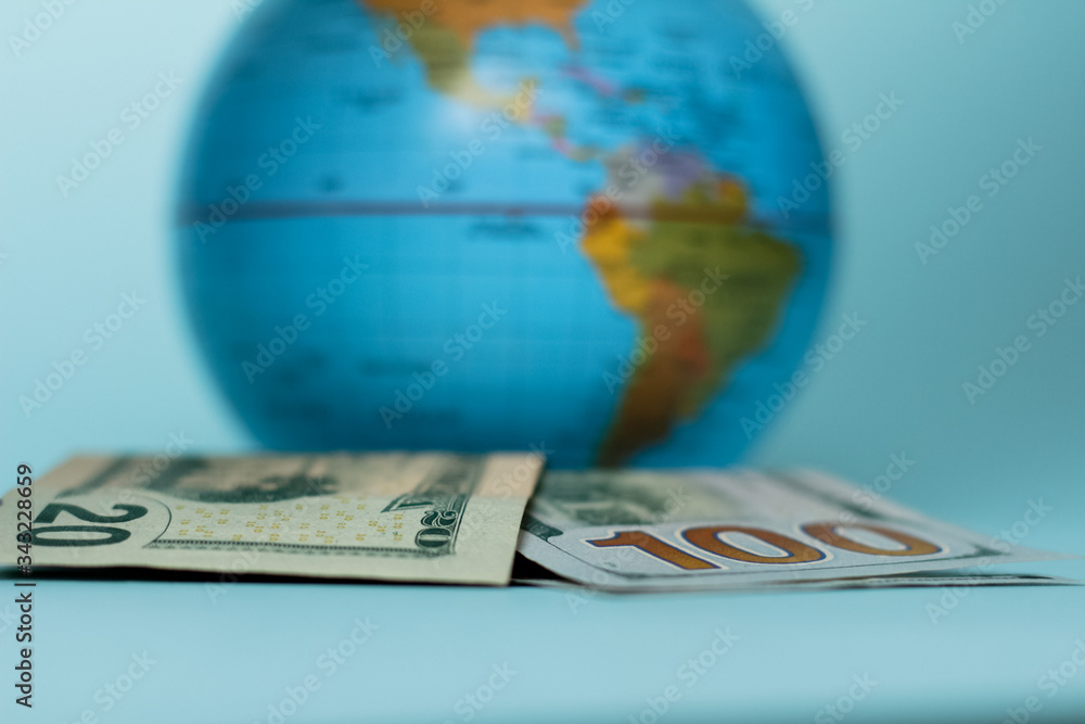 National USA money displaying with one hundred and twenty dollar bills. National USA money with globus and continent of United States of America. Person is taking money from money box. National USA money displaying with one hundred and twenty dollar bills. National USA money with globus and continent of United States of America. Person is taking money from money box.