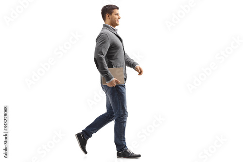 Man holding a book and walking