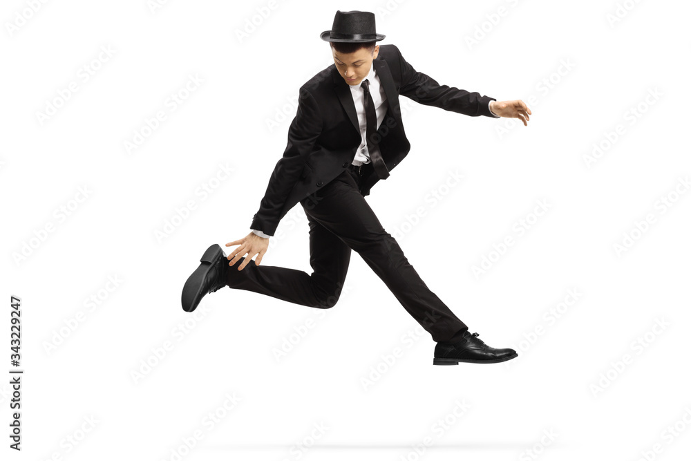 Young man in a suit in a jumping dance pose