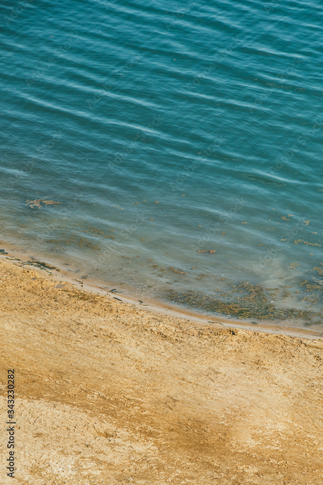 The expanse of the sea meets the sandy beach. Aerial view from quad copter The expanse of the sea meets the sandy beach. Aerial view from quad copter
