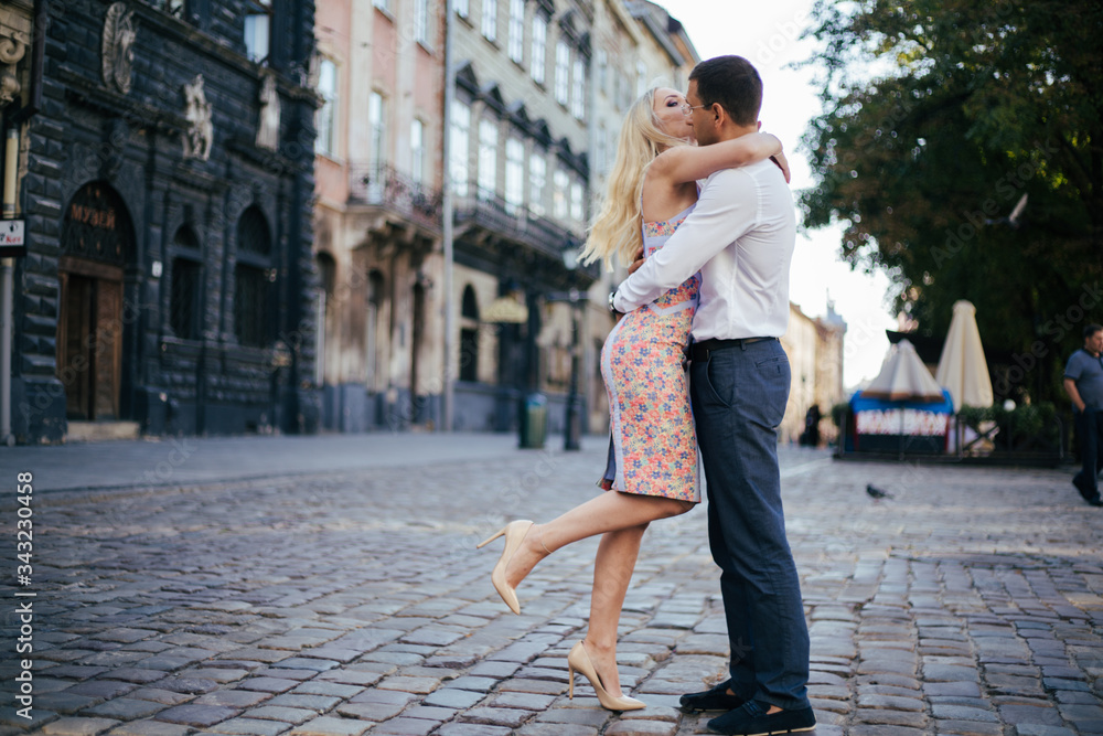 beautiful couple on city background posing, full height