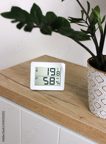 Thermometer hygrometer measuring the optimum temperature and humidity in a house, apartment or office, a photo for articles about the house’s microclimate, health, disease relief and virus treatment